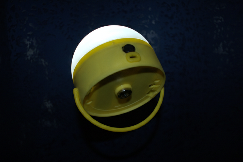 white dome-shaped lamp, yellow bottom with a handle and magnetic attachment 