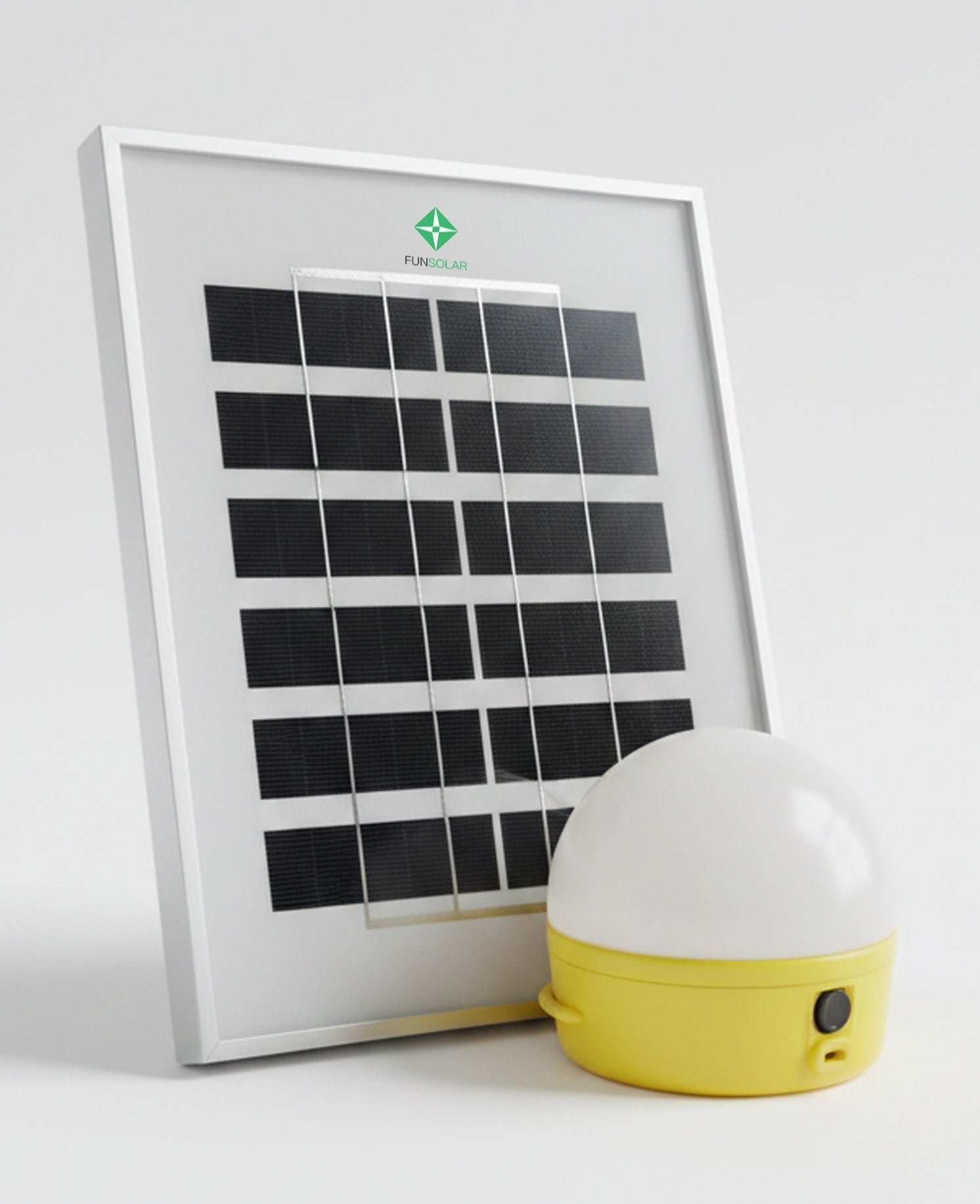 Solar panel and portable light on a white background